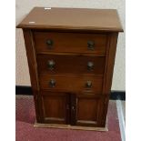 A mahogany three drawer chest with cupboard door base height 70,5 cm.