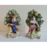 A pair of Derby porcelain figures boy by fire and girl with flowers.