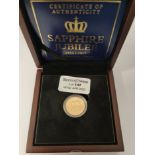 A boxed gold proof £1 coin marking Sapphire Jubilee 1952-2017.