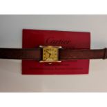 A ladies gold plated silver Must de Cartier wrist watch, the dial having hourly Roman numeral