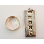 A hallmarked 9ct yellow gold wedding band, ring size X approx. weight 3.5gms, and a silver ingot