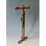 A Joseph Lucas brass King of the road hand pump with wood handle.