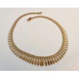 A Cleopatra style fringe necklace, stamped 9kt.