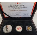 A boxed Canadian three coin proof set commemorating 50th Anniversary of the Canadian Flag