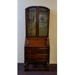 An oak bureau bookcase with two drawers to base.