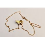 A racing horse pendant, stamped 750, on chain, approx. length 28cm. approx. weight 4.6gms