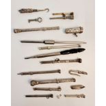 A collection of metal gem set propelling pens and loop, button hooks, key