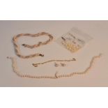 A fancy twist style pearl necklace, a pair of stud earrings, bracelet, loose pearls, single row of