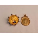 Two coins, one with gem stones, one mounted - not gold.