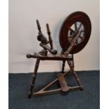 A mahogany spinning wheel.
