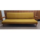 A Guy Rogers Manhattan teak sofa bed and two armchairs.