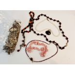 A collection of jewellery two garnet bead necklaces, shell necklace, prayer beads, pearl and black