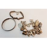 A hallmarked silver charm bracelet with approx. 23 charms, some stamped silver, along with a gate