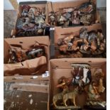 A collection of Native Americans wolves and cowboys figures.