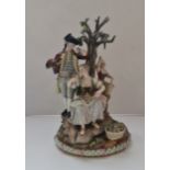 A Meissen blue crossed swords figure group of lady and gentleman with child around tree height 25,