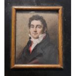 A 19th century portrait miniature on ivory of a gentleman in black coat in wooden frame and label