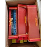 A collection of Hornby 00 gauge rolling stock in boxes.