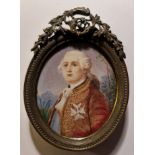 A 19th century portrait miniature on ivory of a Georgian gentleman with white hair and cross to