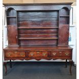 An 18th century oak three drawer dresser base with raised plate rack top length 184,5 cm.