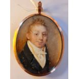 A Georgian portrait miniature on ivory of a gentleman with ginger hair in black jacket in 9ct gold