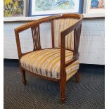 An Edwardian mahogany tub chair on square tapered legs.