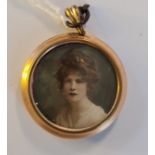 An overpainted print portrait miniature of a 1920s lady in circular gilt metal frame and locket