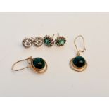 A pair of stamped 14k green cabochan style earrings, together with a pair of green stone cluster