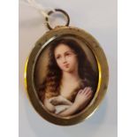 A portrait miniature on ceramic disk of a young woman praying in oval picture frame style metal