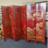 A six panel Chinese red lacquered with gold paint dressing screen height 183 cm.