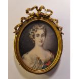 A 19th century portrait miniature on ivory of a lady with flowers in her hair and white dress with