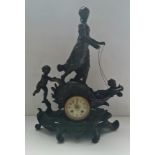 A large spelter French clock with lady and cherubs on sledge height 51 cm.