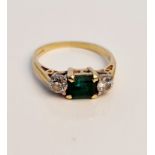 A hallmarked 18ct yellow gold emerald and diamond three stone ring, approx. total diamond weight 0.