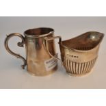 A hallmarked silver tankard, approx. height 8cms, and a hallmarked silver cream jug, approx. total