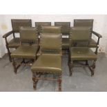 A set of eight oak and green leather dining chairs.