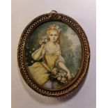 A 19th century portrait miniature on ivory of a young lady holding flowers in a yellow dress in an