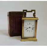 A small brass carriage clock with travel box.