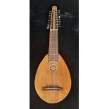 A Lute guitar flat backed model with seven courses plus five lower strings sixteen strings in