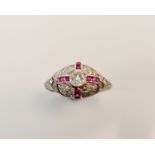 A diamond and ruby dress ring, set with a central old cut diamond measuring approx. 0.33ct, the