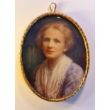 A portrait miniature on ivorine of a lady from 1920s/1930s in a white shawl and light blue dress