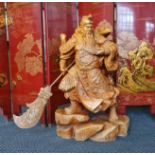 A large carved wooden Chinese warrior figure on rocks height 86 cm.