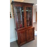 A 19th century mahogany two door glazed top bookcase on cupboard base height 213 cm.