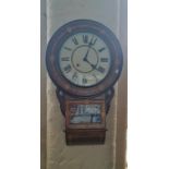 A rosewood inlaid round face wall clock.