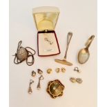 A pearl style pendant on chain with various clip and screw on stud earrings, an oval decorative