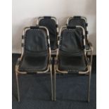 A set of four Charlotte Perriand design chairs chrome framed and dark blue leather seats.
