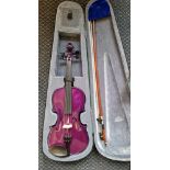 A Carlo Giordiano 3/4 purple violin outfit in green case and bow.