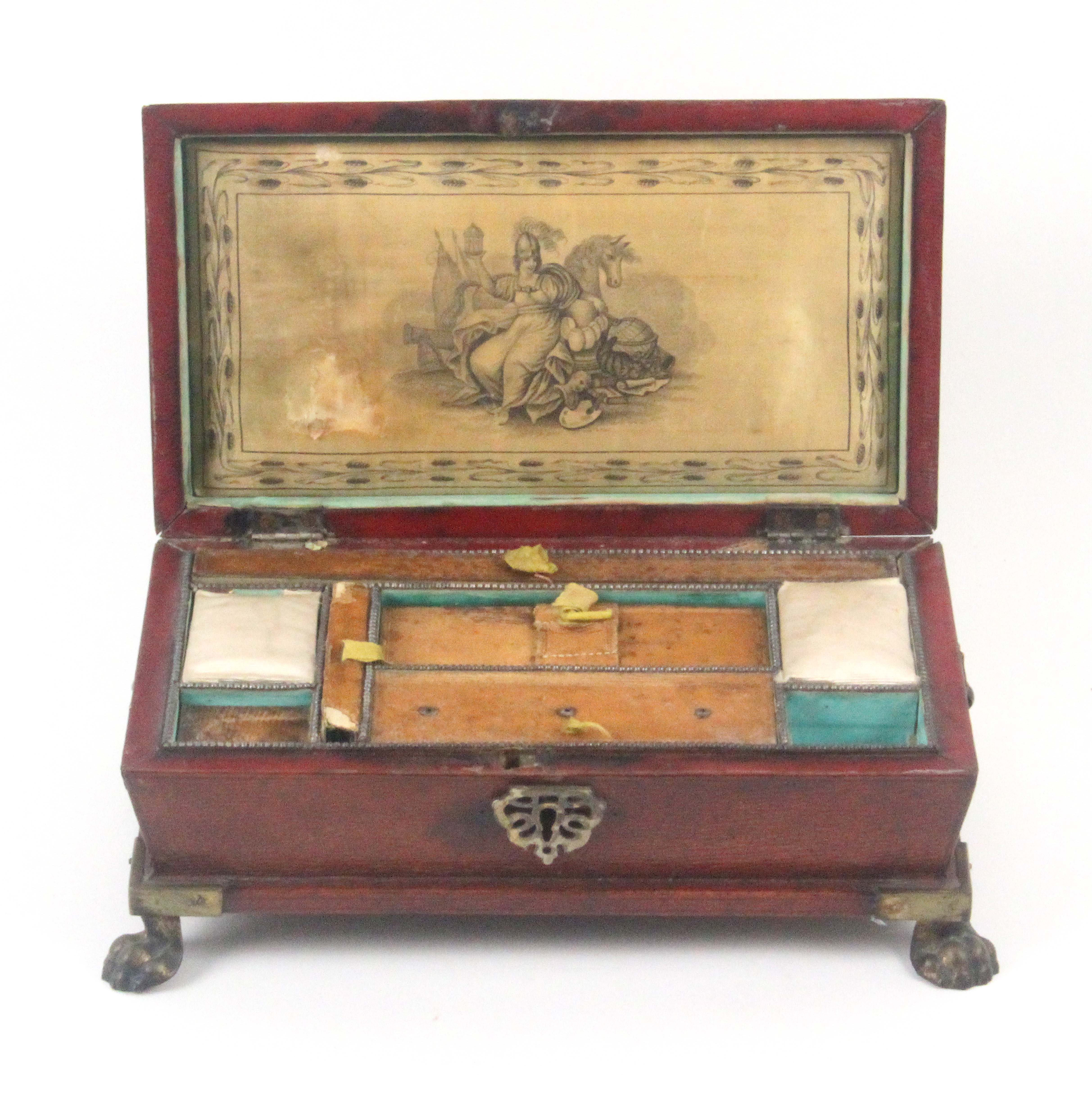 A Regency red leather sewing box, circa 1815, of sarcophagol form raised on brass paw feet, leaf - Image 2 of 2