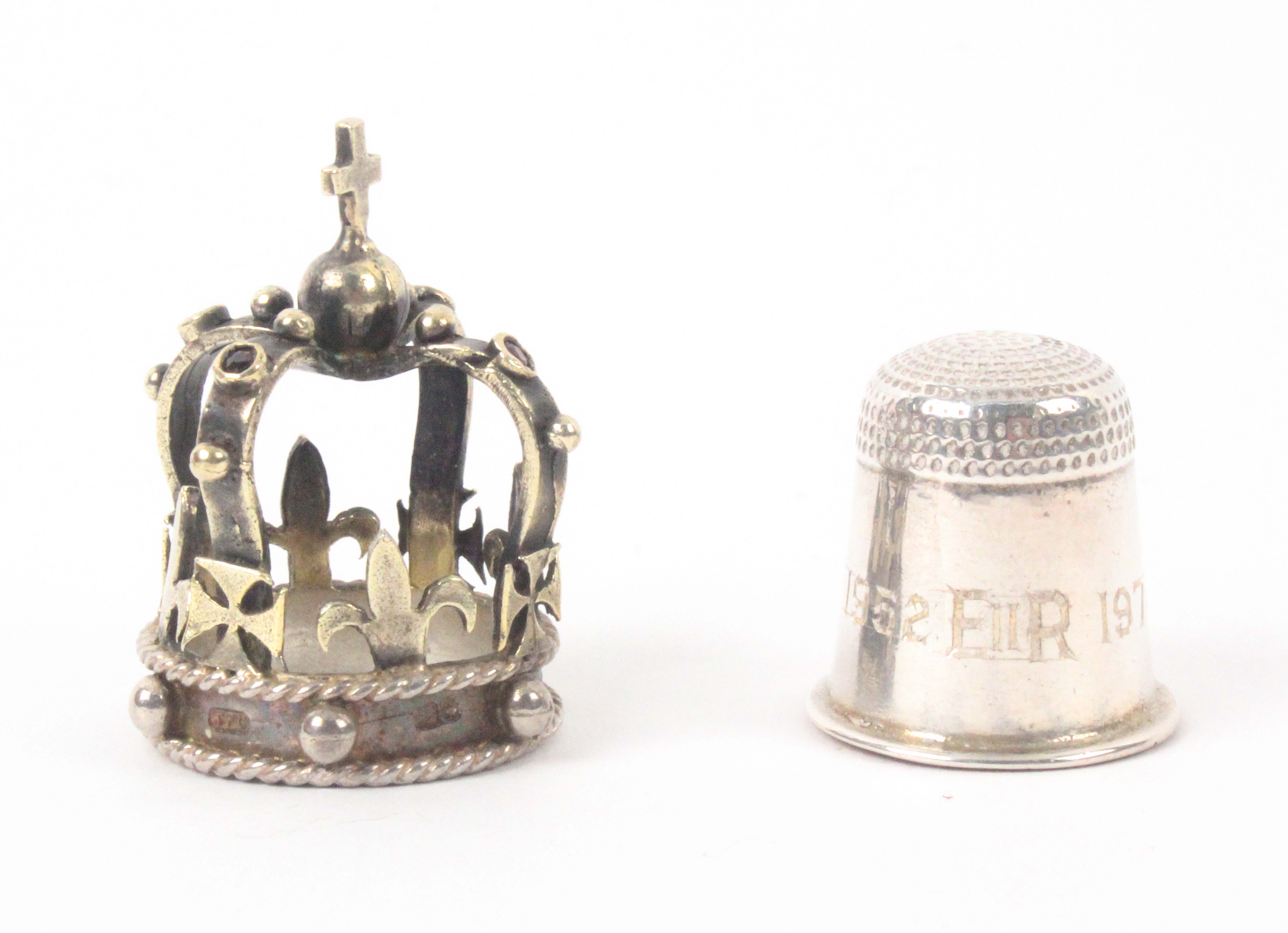 A limited edition silver thimble and crown cover commemorating the Silver Jubilee of Queen Elizabeth