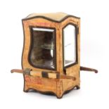 A late 19th/early 20th Century table display case in the form of a miniature sedan chair, the wooden