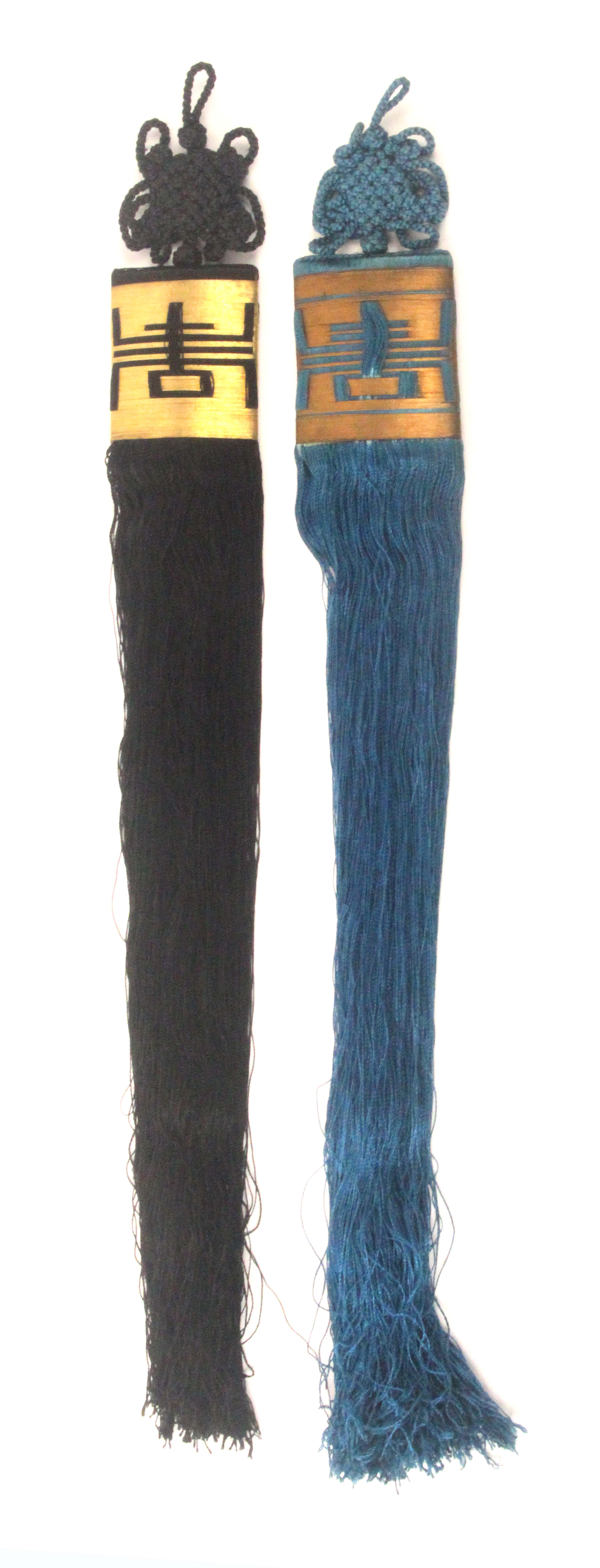 A pair of Chinese tassels, late 19th / early 20th Century, one in black, one in blue, gilt thread
