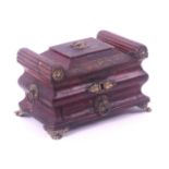 A Regency red leather and gilt tooled sewing box, circa 1810, of sarcophagol form, the lid with